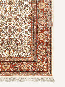 Corner shot of a traditional design hand knotted Indian carpet also known as a oriental rug.
