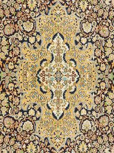 Close up shot of a Kashmiri Carpet made in India with intricate vines and flowers knitted on a handknotted rug.